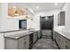 Basement bar with gray cabinets, wine storage, and a long countertop at 457 S Vine St, Denver, CO 80209