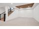 Unfinished basement with carpeted floors and a staircase at 457 S Vine St, Denver, CO 80209