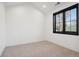 Spacious bedroom with neutral walls and carpet, featuring a large window at 457 S Vine St, Denver, CO 80209