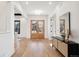 Light and airy entryway with hardwood floors and a view to the living area at 457 S Vine St, Denver, CO 80209