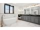 Elegant bathroom with double vanity, soaking tub and marble floors at 457 S Vine St, Denver, CO 80209
