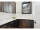 Well-lit pantry with white tile and dark cabinetry at 457 S Vine St, Denver, CO 80209