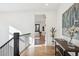 Light and airy upper hallway with hardwood floors and artwork at 457 S Vine St, Denver, CO 80209