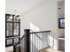 Bright upper hallway with black railing and natural light at 457 S Vine St, Denver, CO 80209