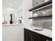 Modern wet bar with dark cabinetry and quartz countertop at 457 S Vine St, Denver, CO 80209