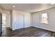 Bedroom with wood-look floors, closet, and access to bathroom at 15360 W 44Th Ave, Golden, CO 80403