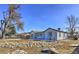 Ranch style home with landscaped yard, rock garden, and fenced yard at 15360 W 44Th Ave, Golden, CO 80403