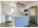 Modern kitchen with white cabinets, island, and stainless steel appliances at 15360 W 44Th Ave, Golden, CO 80403