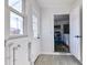 Bright laundry room with tile floor, storage shelves, and a new water heater at 15360 W 44Th Ave, Golden, CO 80403