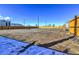 Vacant lot with wooden fence and partial snow cover at 15360 W 44Th Ave, Golden, CO 80403