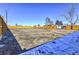 Large vacant lot with wooden fence and partial snow cover at 15360 W 44Th Ave, Golden, CO 80403