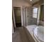 Bathroom with a large bathtub, shower, and walk-in closet at 21064 E Crestline Cir, Centennial, CO 80015