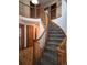 Elegant curved staircase with wooden railings and carpeting at 21064 E Crestline Cir, Centennial, CO 80015