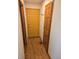 Hardwood floor hallway with coat hooks and access to other rooms at 21064 E Crestline Cir, Centennial, CO 80015
