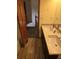 Bathroom with double vanity, tile flooring and view to staircase at 21064 E Crestline Cir, Centennial, CO 80015