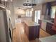 Kitchen with island, hardwood floors, and stainless steel appliances at 21064 E Crestline Cir, Centennial, CO 80015