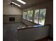 Gathering room with brick fireplace, hardwood floors, and access to backyard at 21064 E Crestline Cir, Centennial, CO 80015