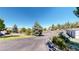 Community entrance with paved roads and landscaping at 6301 Perry Park Blvd # 13, Larkspur, CO 80118