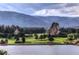 Serene lake view with golf course and mountain scenery at 6301 Perry Park Blvd # 13, Larkspur, CO 80118