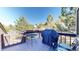 Deck with grill and seating area, overlooking trees at 6301 Perry Park Blvd # 13, Larkspur, CO 80118