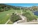 Aerial view of a golf course with a lake at 6301 Perry Park Blvd # 13, Larkspur, CO 80118