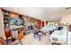 Bright living room with a stone fireplace and large windows at 6301 Perry Park Blvd # 13, Larkspur, CO 80118