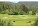 Golf course with players and rolling hills at 6301 Perry Park Blvd # 13, Larkspur, CO 80118