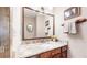Small bathroom with granite countertop and wooden cabinets at 6301 Perry Park Blvd # 13, Larkspur, CO 80118