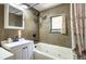 Bathroom with a soaking tub and mosaic tile accents at 5673 Santa Clara Rd, Indian Hills, CO 80454