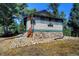 Rustic home with stone foundation and screened porch at 5673 Santa Clara Rd, Indian Hills, CO 80454