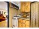 Rustic kitchen with wood cabinets, granite counters, and a view at 5673 Santa Clara Rd, Indian Hills, CO 80454