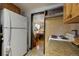 Cabin kitchen with white appliances and wood cabinets at 5673 Santa Clara Rd, Indian Hills, CO 80454