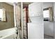 Convenient laundry room with stackable washer and dryer at 5673 Santa Clara Rd, Indian Hills, CO 80454