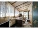 Sunlit home office features a desk and comfortable seating at 5673 Santa Clara Rd, Indian Hills, CO 80454