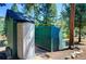 Gray plastic shed and green wooden fence at 5673 Santa Clara Rd, Indian Hills, CO 80454