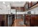 Modern kitchen with dark wood cabinets and stainless steel appliances at 16258 E Elk Dr, Denver, CO 80239