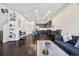 Open concept living room with dark hardwood floors and kitchen view at 16258 E Elk Dr, Denver, CO 80239