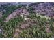 Wide aerial view of a house nestled in a mountainous, wooded area at 9310 S Watson Gulch Rd, Littleton, CO 80127