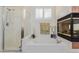 Relaxing bathroom with a large bathtub, shower, and a fireplace at 12955 Vallejo Cir, Westminster, CO 80234