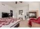 Bright bedroom with a king-size bed, fireplace, and access to the bathroom at 12955 Vallejo Cir, Westminster, CO 80234