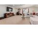 Spacious bonus room with sectional sofa, large TV, and a work area at 12955 Vallejo Cir, Westminster, CO 80234