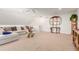 Spacious bonus room with comfortable seating and a large TV at 12955 Vallejo Cir, Westminster, CO 80234