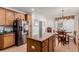 Open kitchen with island, stainless steel appliances, and breakfast nook at 12955 Vallejo Cir, Westminster, CO 80234