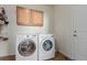 Laundry room with washer, dryer, and storage cabinets at 12955 Vallejo Cir, Westminster, CO 80234