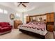 Main bedroom with a large bed and built-in wood furniture at 12955 Vallejo Cir, Westminster, CO 80234