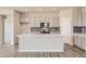 Modern kitchen featuring gray cabinets, an island, and stainless steel appliances at 9994 Racine St, Commerce City, CO 80022