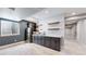 Basement wet bar with granite countertops, dark cabinetry, and stainless steel appliances at 1061 Equinox Ln, Erie, CO 80516