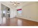 Bright bedroom featuring hardwood floors, a ceiling fan, and a large window at 930 E Plum Creek Pkwy # 206, Castle Rock, CO 80104