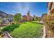 Spacious backyard with lush lawn and mature trees at 14672 Melco Ave, Parker, CO 80134