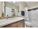Bathroom with shower/tub combo and wood vanity at 14672 Melco Ave, Parker, CO 80134
